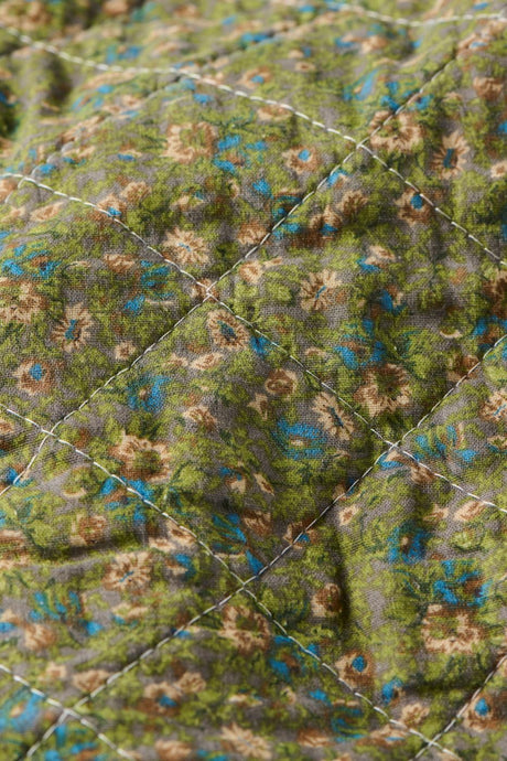 Närbild av småblommigt mönster på en quilt från Ib Laursen i dämpade färger