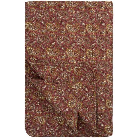 Rosa quilt från Ib Laursen med tätt paisleymönster i mörkrosa, gröna och gråaktiga nyanser