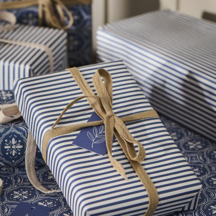 Gave pakket ind i Ib Laursen gavepapir med blå/hvide striber og beige bånd